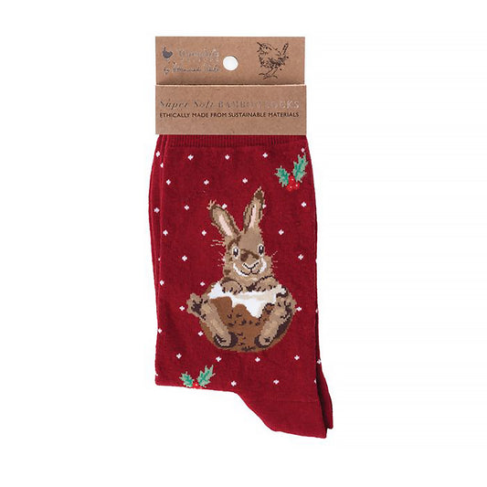 A folded pair of Christmas socks in red with a rabbit in a Christmas pudding 