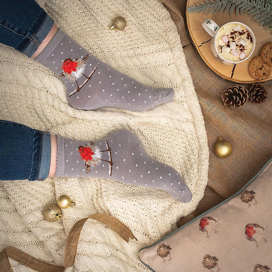 Model wearing pair of Christmas socks in grey with a robin and polka dots lifestyle