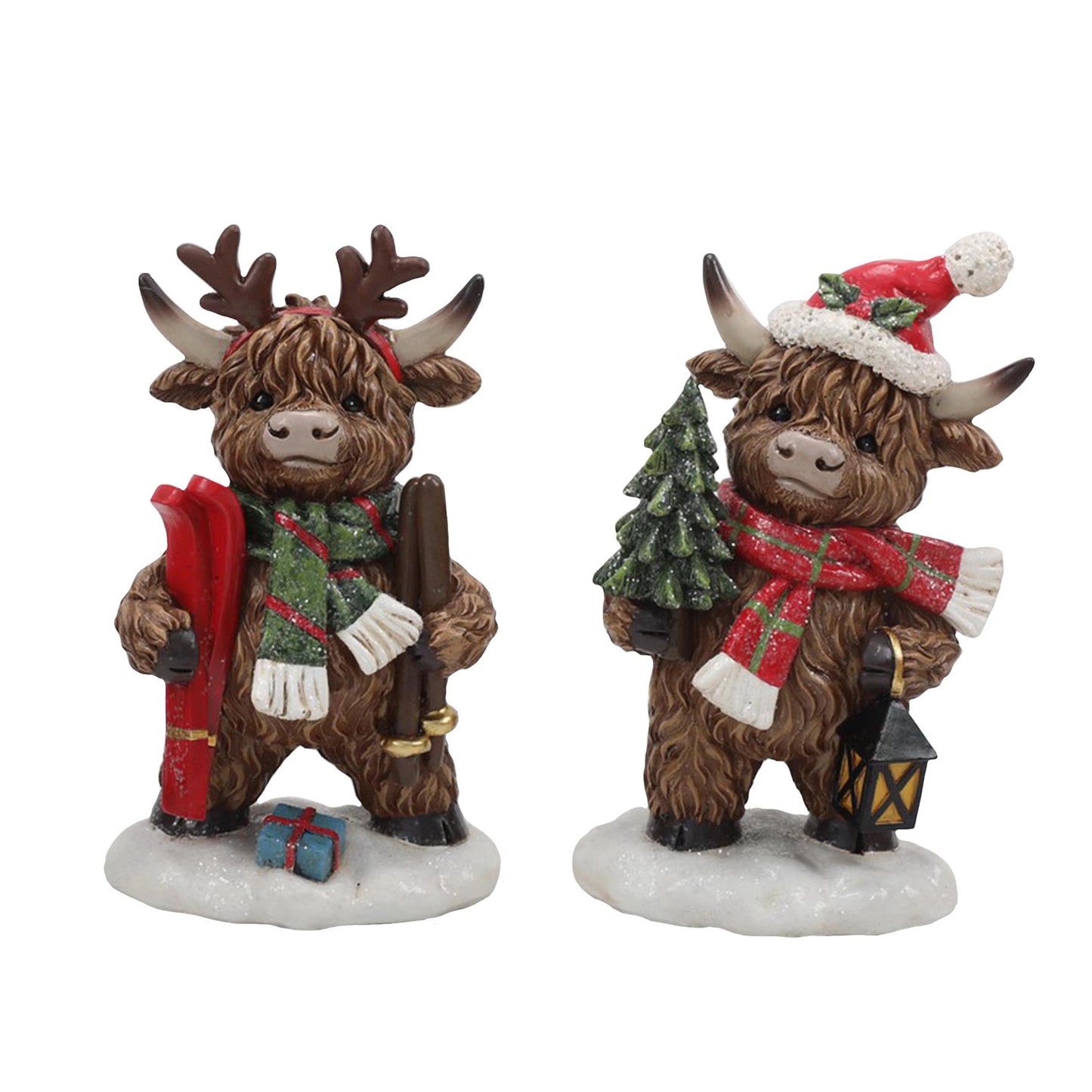 Highland cow Christmas figures with skis and a Christmas tree