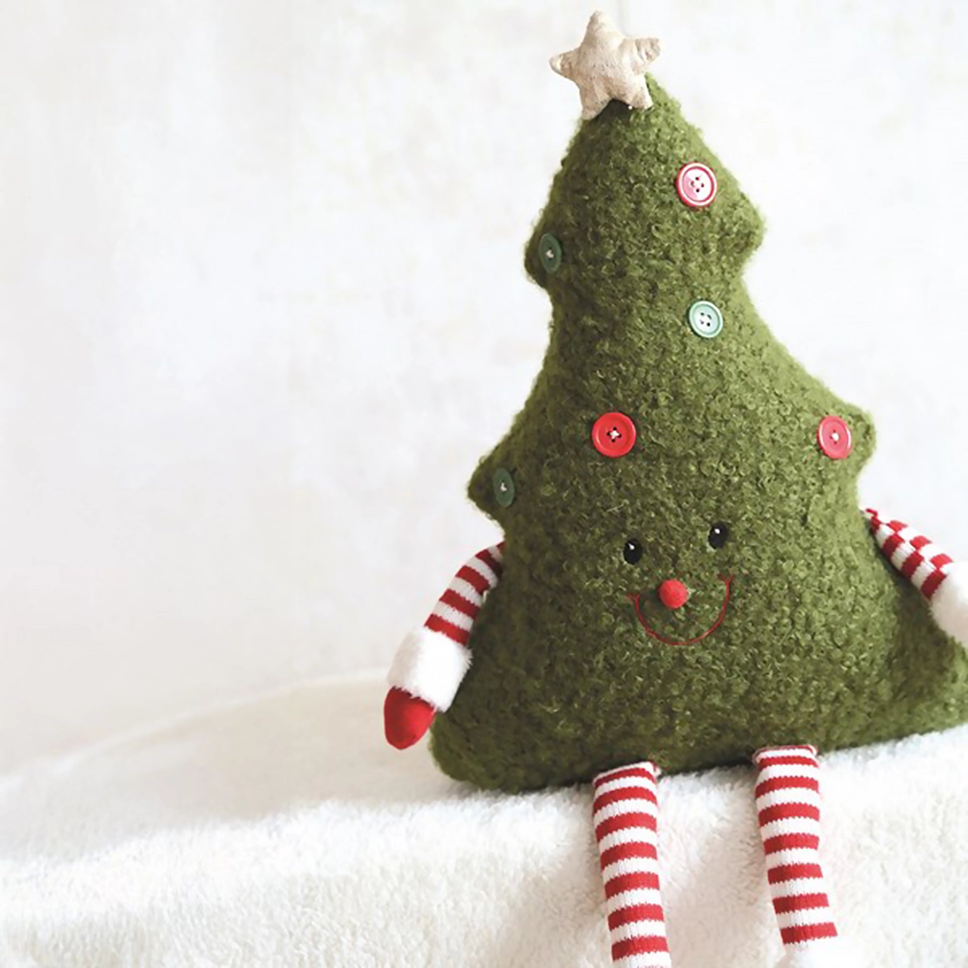 Green boucle novelty Christmas tree shaped cushion with dangling legs and arms