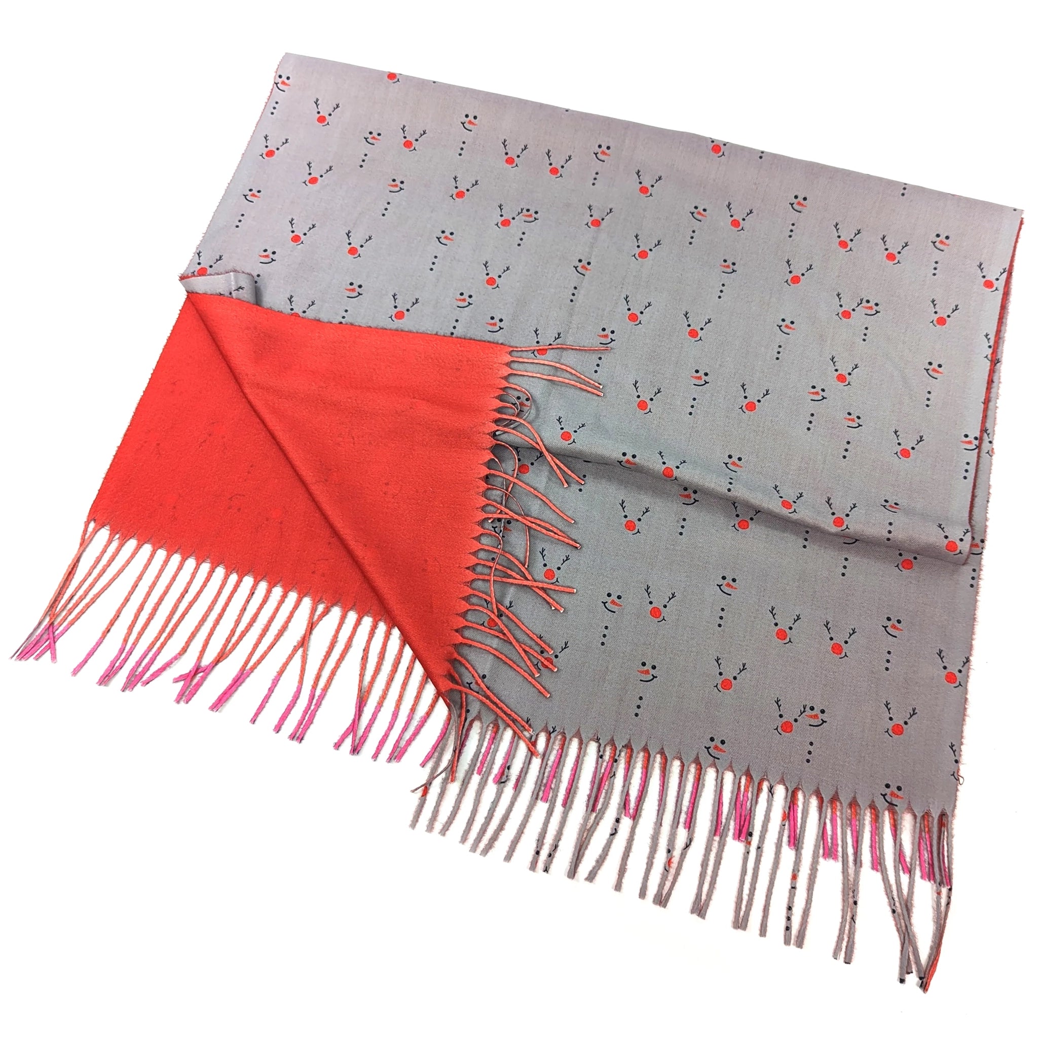 A pashmina style scarf, one side with a pattern of snowmen and reindeer on grey and the other a plain red