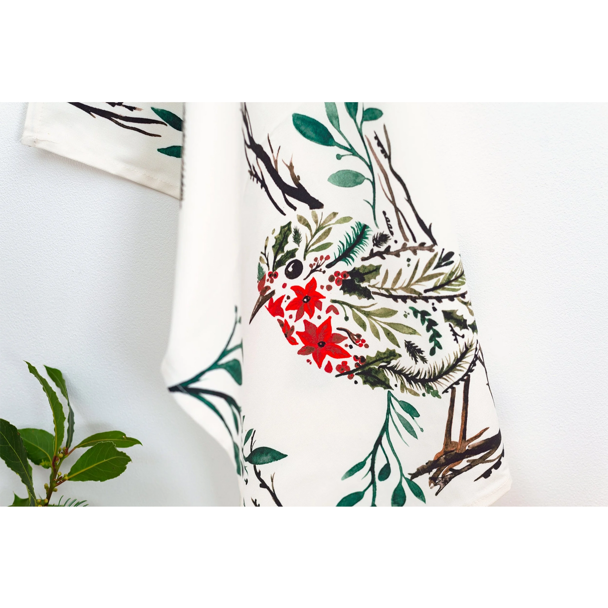 Christmas white cotton tea towel featuring a floral design with a robin detail