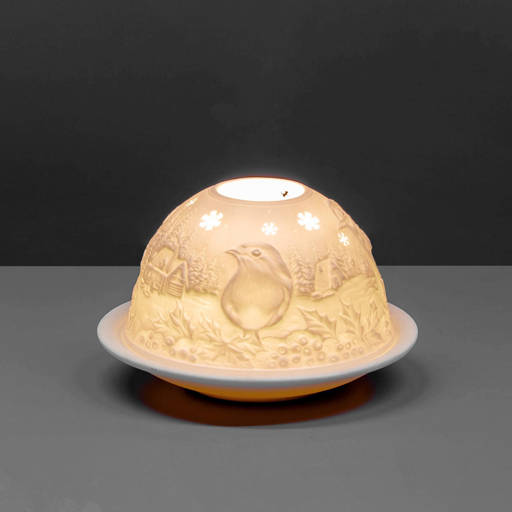 White porcelain dome candle holder with a Christmas robin design lit up 2