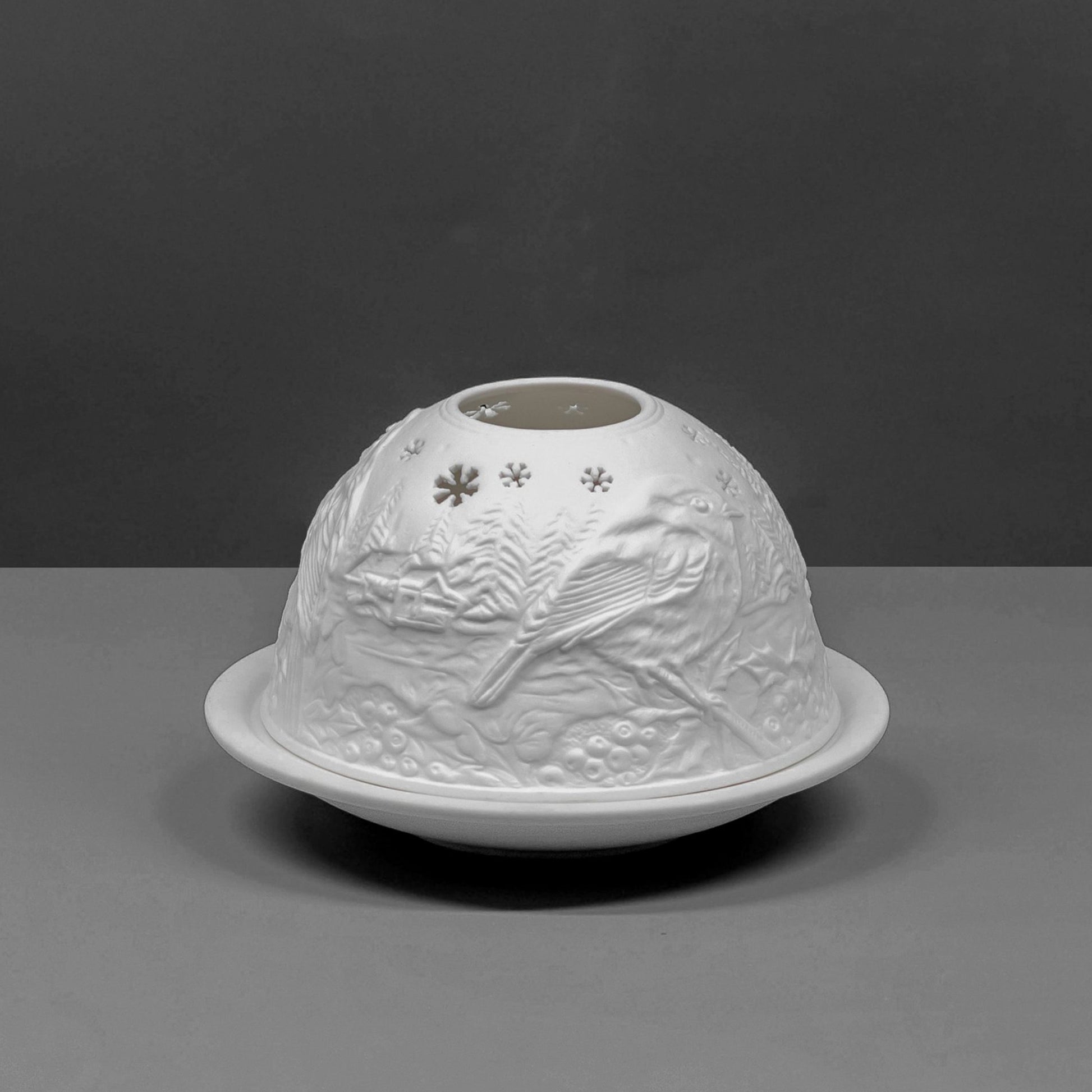 White porcelain dome candle holder with a Christmas robin design