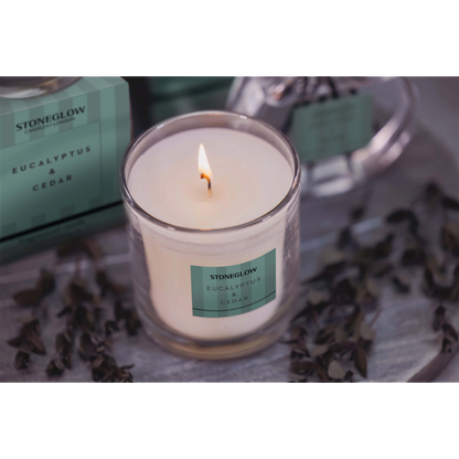 Stoneglow Eucalyprus & Cedar tumbler candle with green striped packaging lifestyle