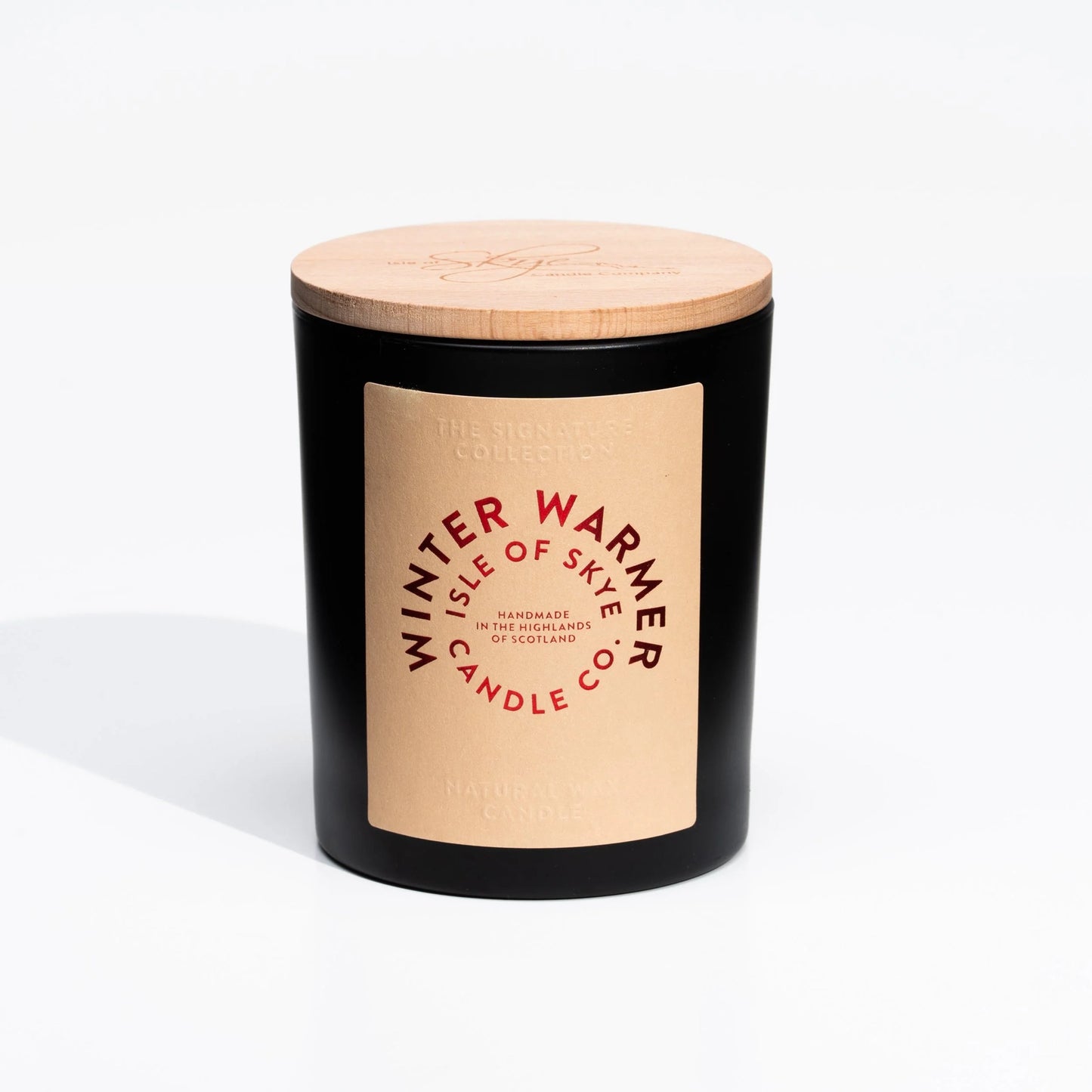 Black tumbler candle with wooden lid in the scent Winter Warmer by Isle of Skye Candle Co.