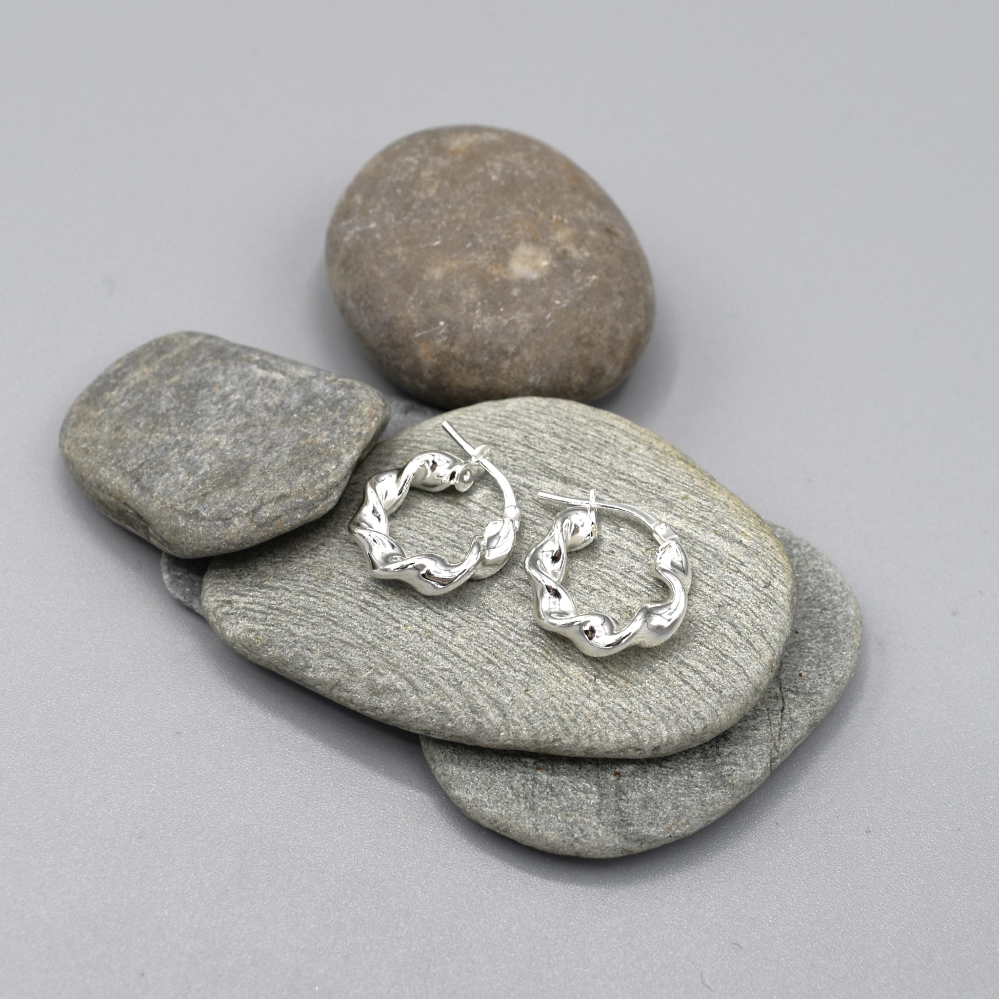 A pair of elegant chunky twist shaped hoop earrings