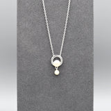 Pendant with a simple circle set with a pearl and a smaller drop pearl at the bottom