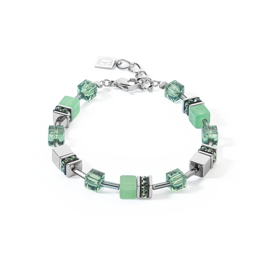 A steel bracelet featuring a variety of cube shaped stones including green aventurine