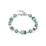 A steel bracelet featuring a variety of cube shaped stones including green aventurine