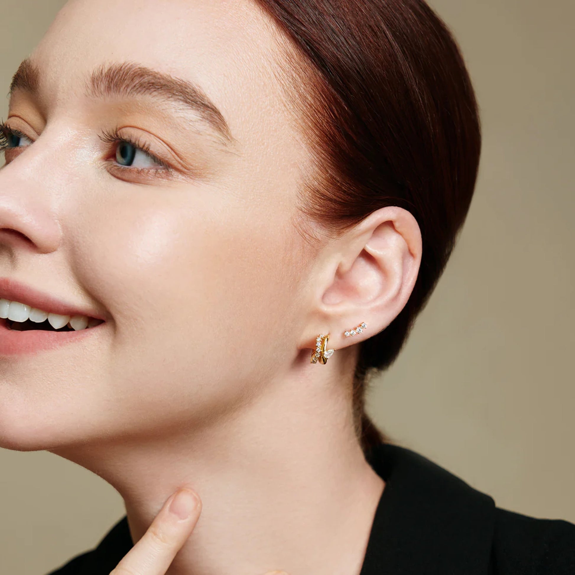 Model wearing pave gold studs with climbing CZ stones