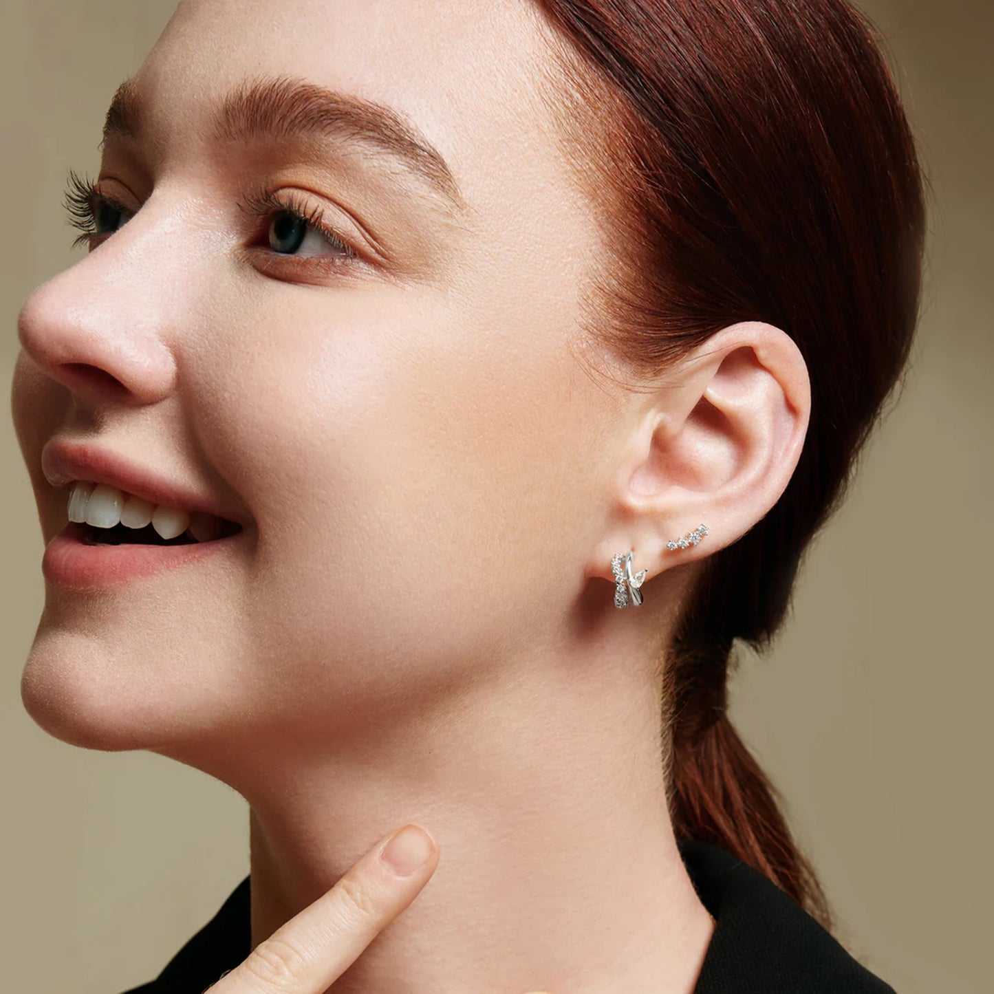 Model wearing pave silver studs with climbing CZ stones