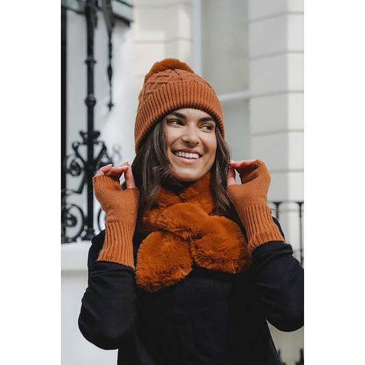Model wearing a set of brown items, including a knitted pompom hat, long fingerless gloves, and a short faux fur scarf