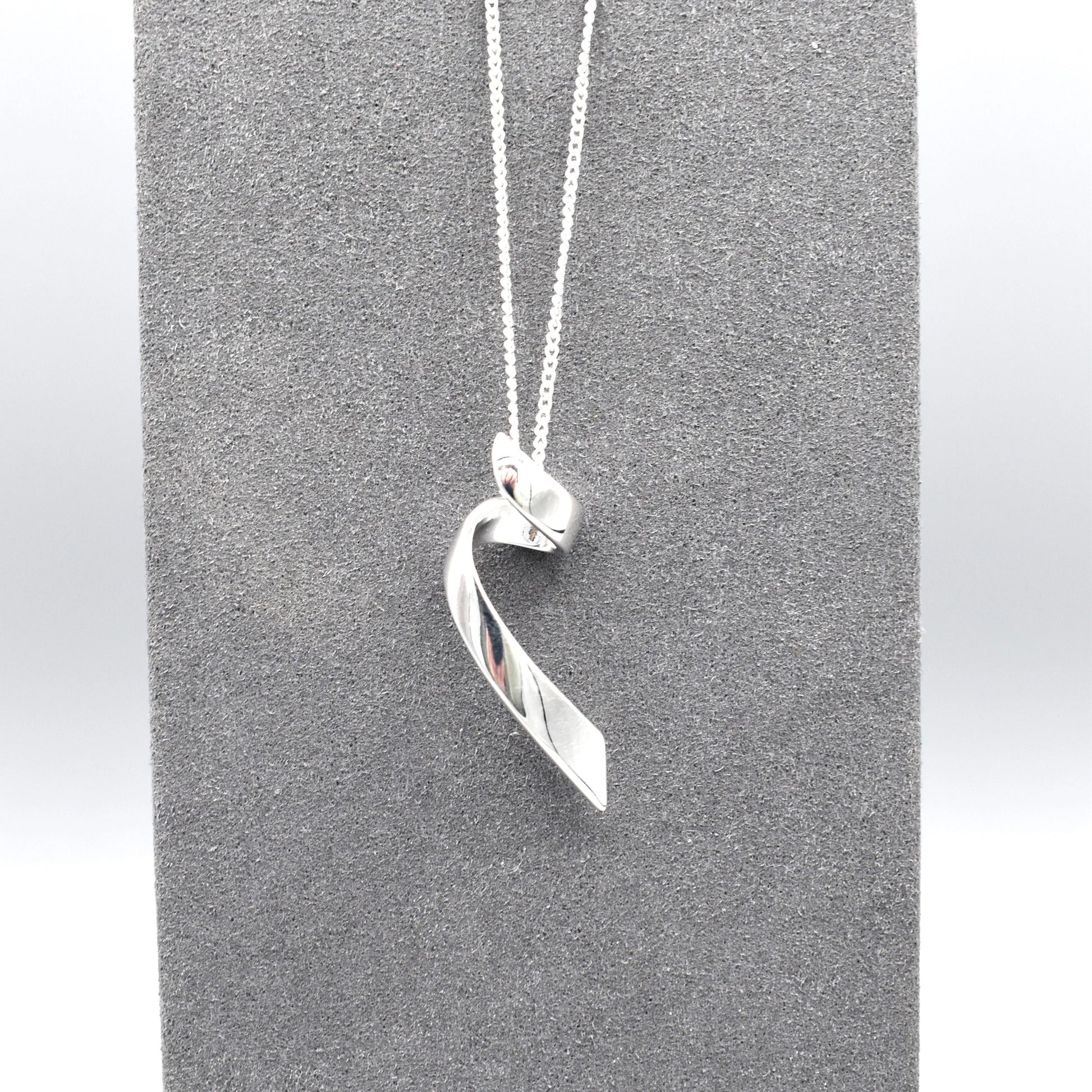 Pendant featuring a simple silver loose coil twist design