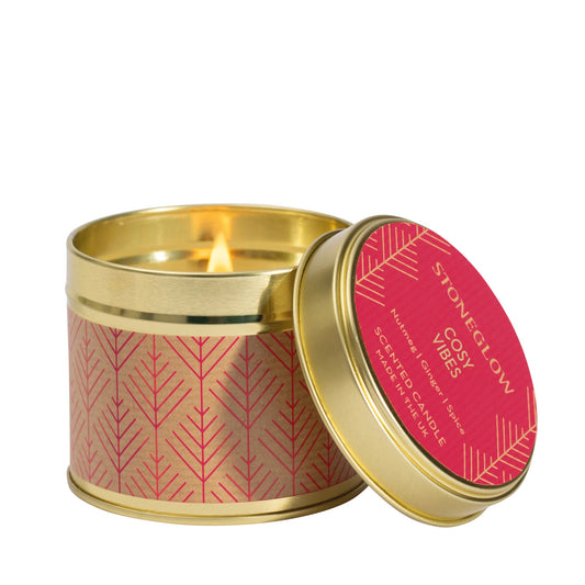 A gold coloured candle tin with red Scandi style pattern in the scent 'Cosy Vibes'