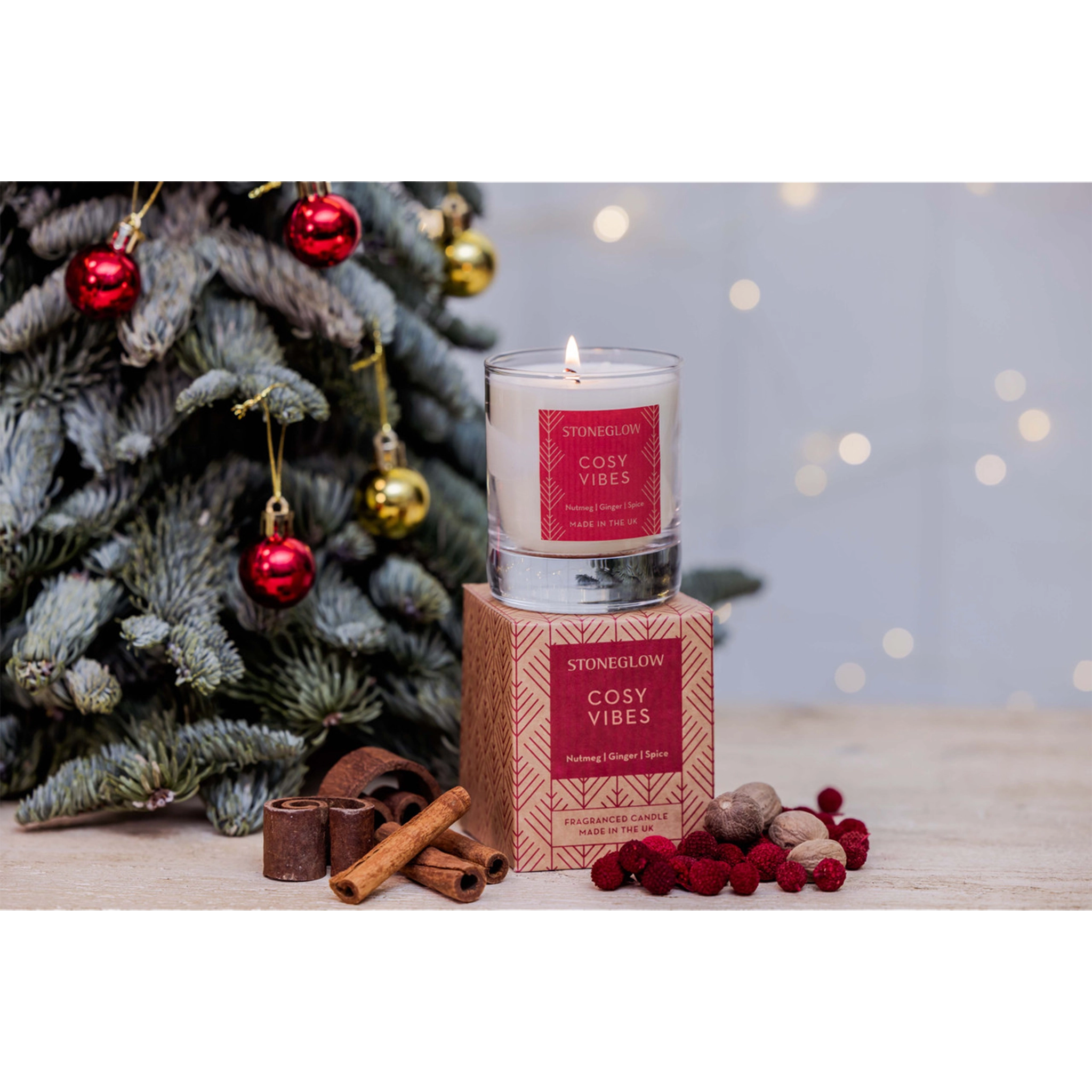 A glass candle tumbler with a box decorated in a red Scandi style pattern - lifestyle image