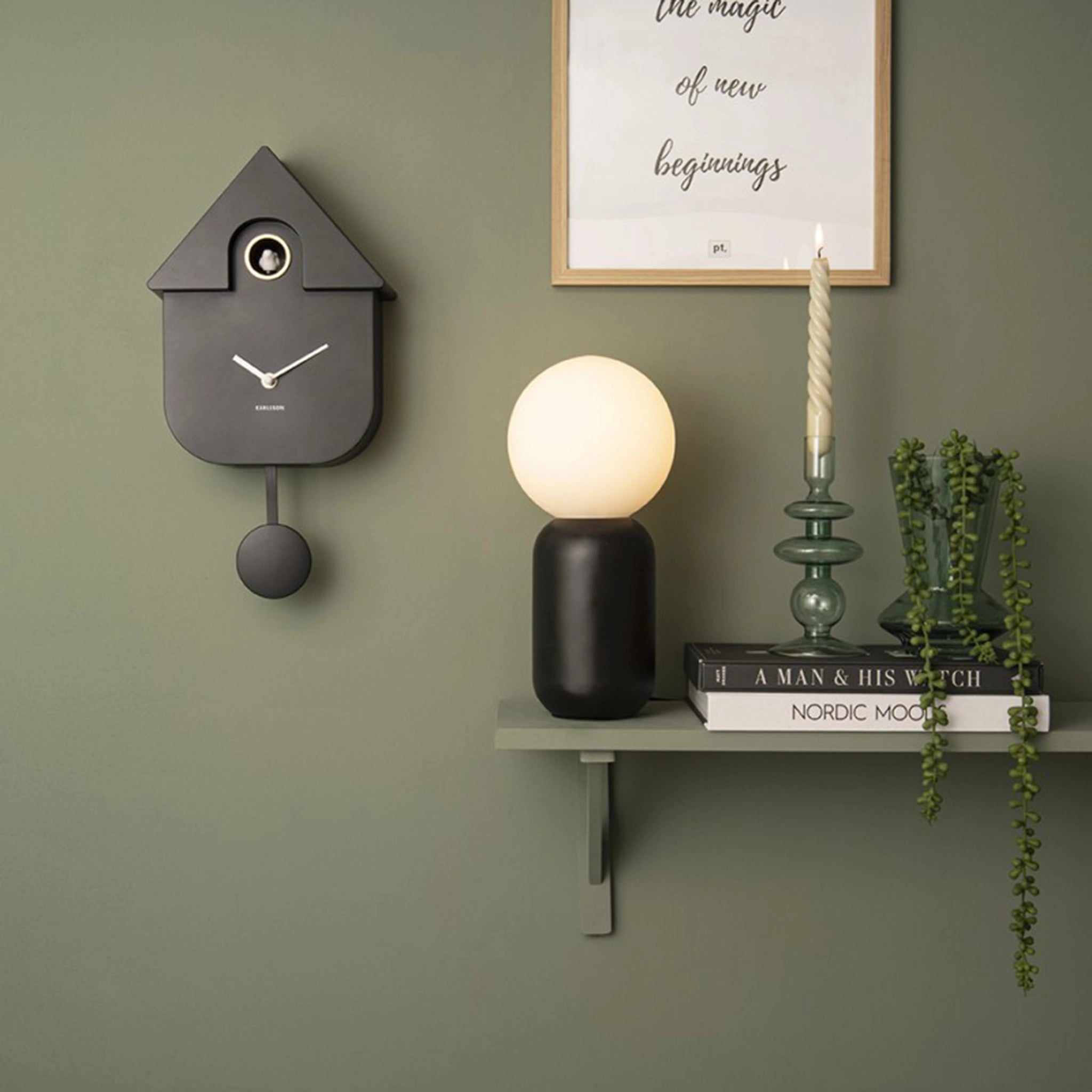 A black modern cuckoo clock on wall