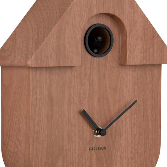 Detail view of a dark wood finish modern cuckoo wall clock