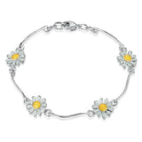 Polished silver bracelet with repeat silver bars and daisy pendants in white and yellow enamel