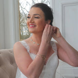 Model at a wedding wearing a polished silver daisy necklace with repeating links in yellow and white enamel