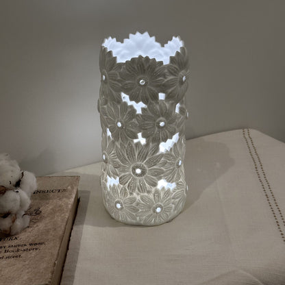 A porcelain lamp with 3D effect daisy flower design lit up