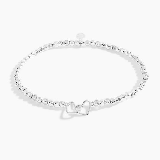 A silver beaded bracelet with silver interlinking circles