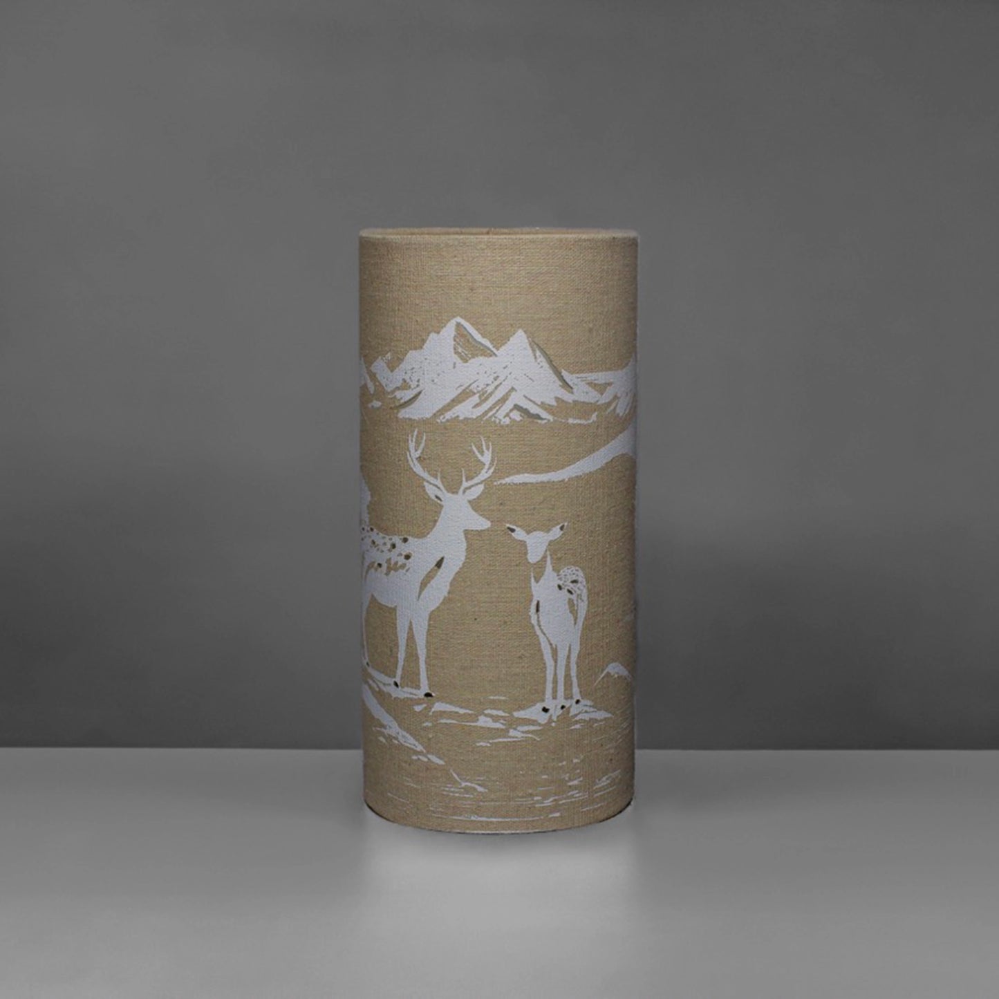 A linen look fabric table lamp with a love deer design and cut out details