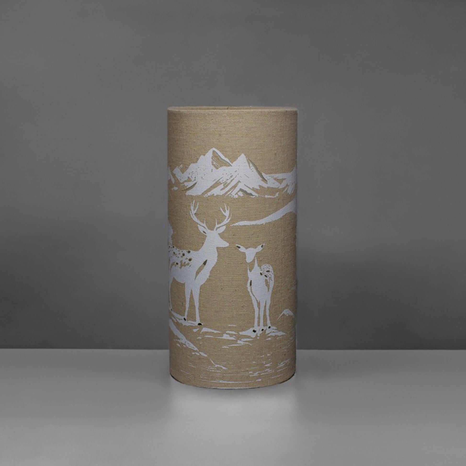 A linen look fabric table lamp with a love deer design and cut out details