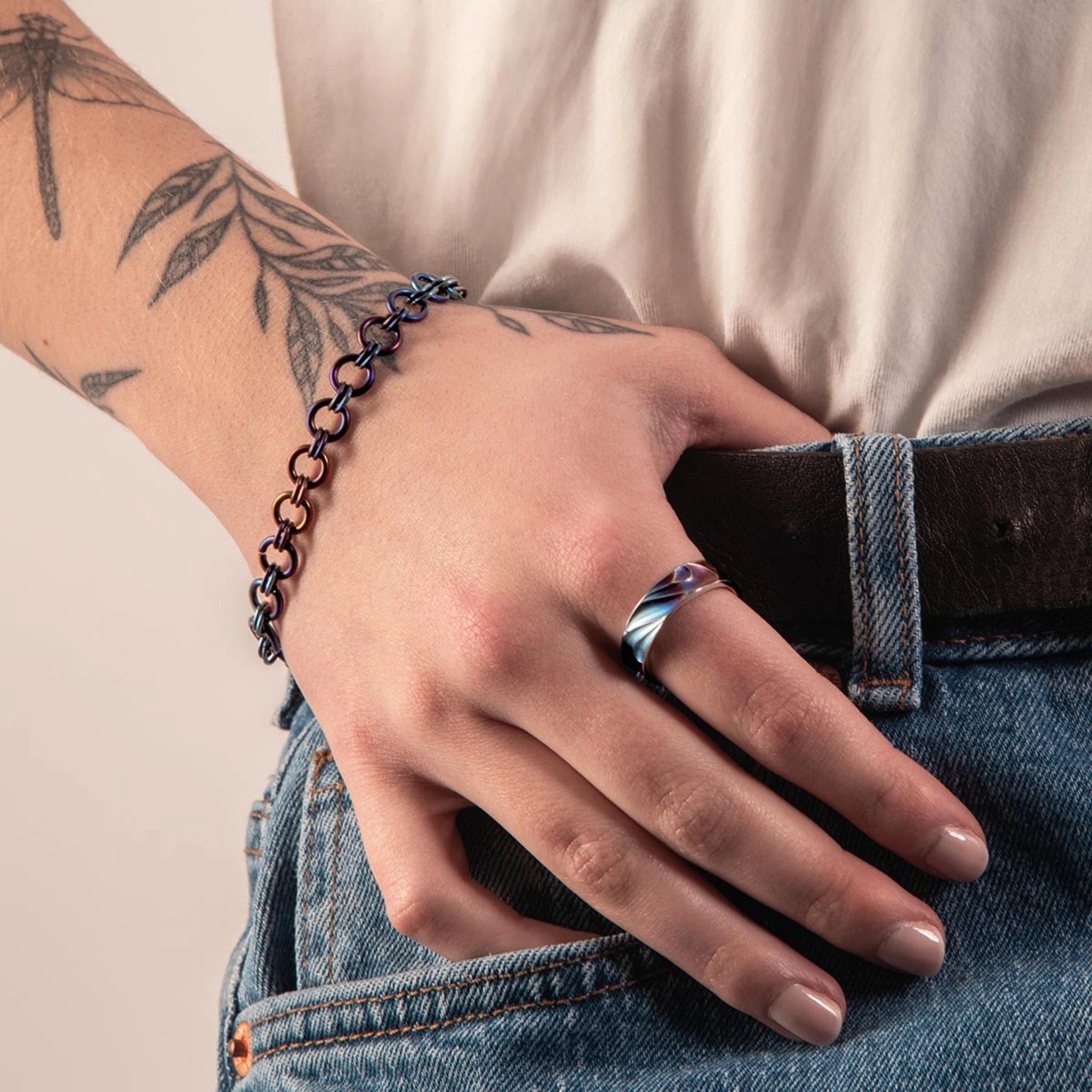 Model wearing a chainmail link titanium bracelet in blue and copper tones