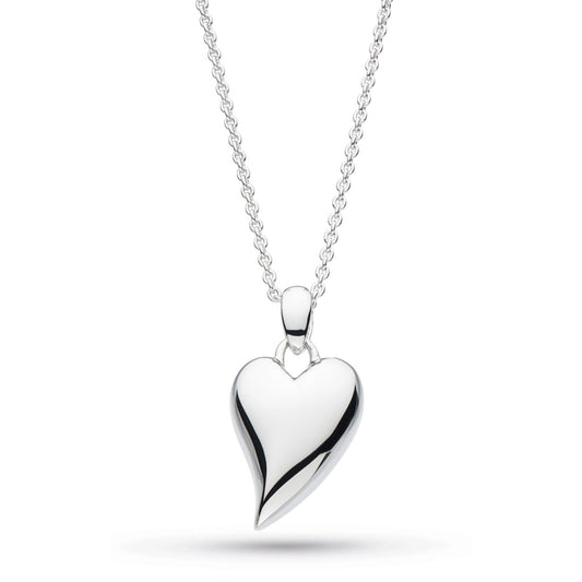 A simple silver pendant on a chain in the shape of a heart