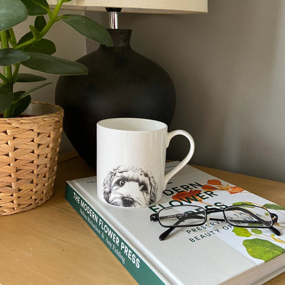 White mug with screen printed cockapoo illustration in graphite - lifestyle