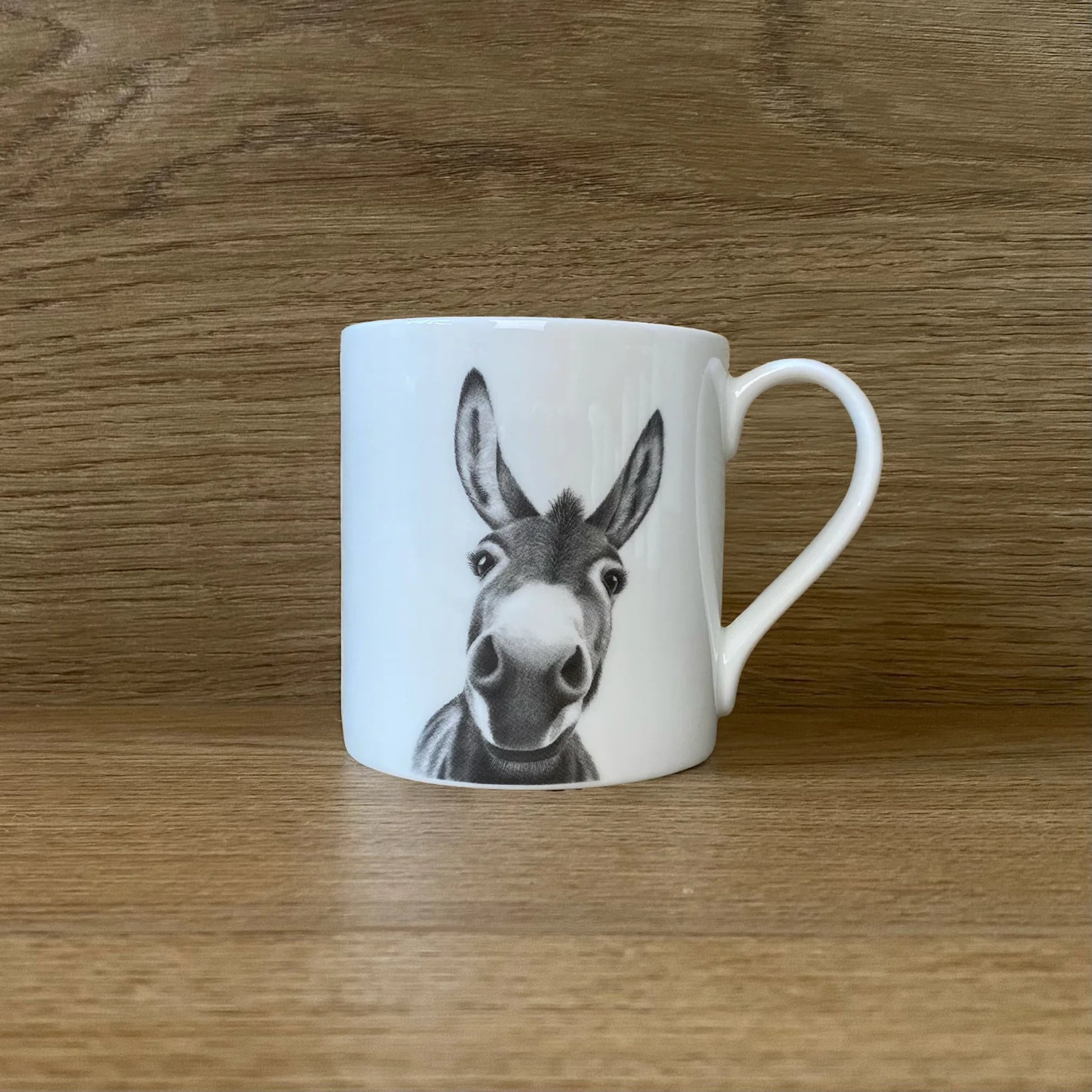 White mug with a grey illustration of a donkey