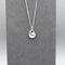 A double twisted teardrop shaped pendant with matt silver