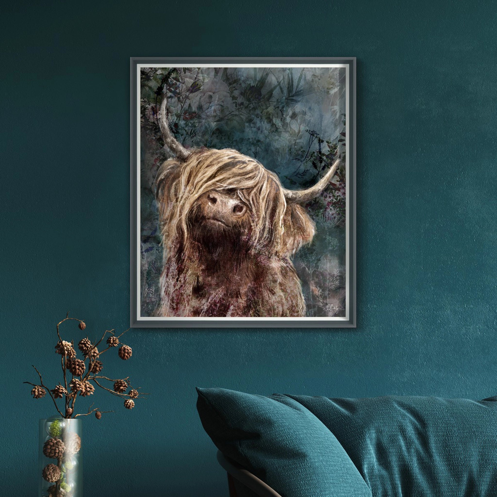 Framed canvas print of a red Highland cow with an impressionist blue background of foliage hanging in a dark room.