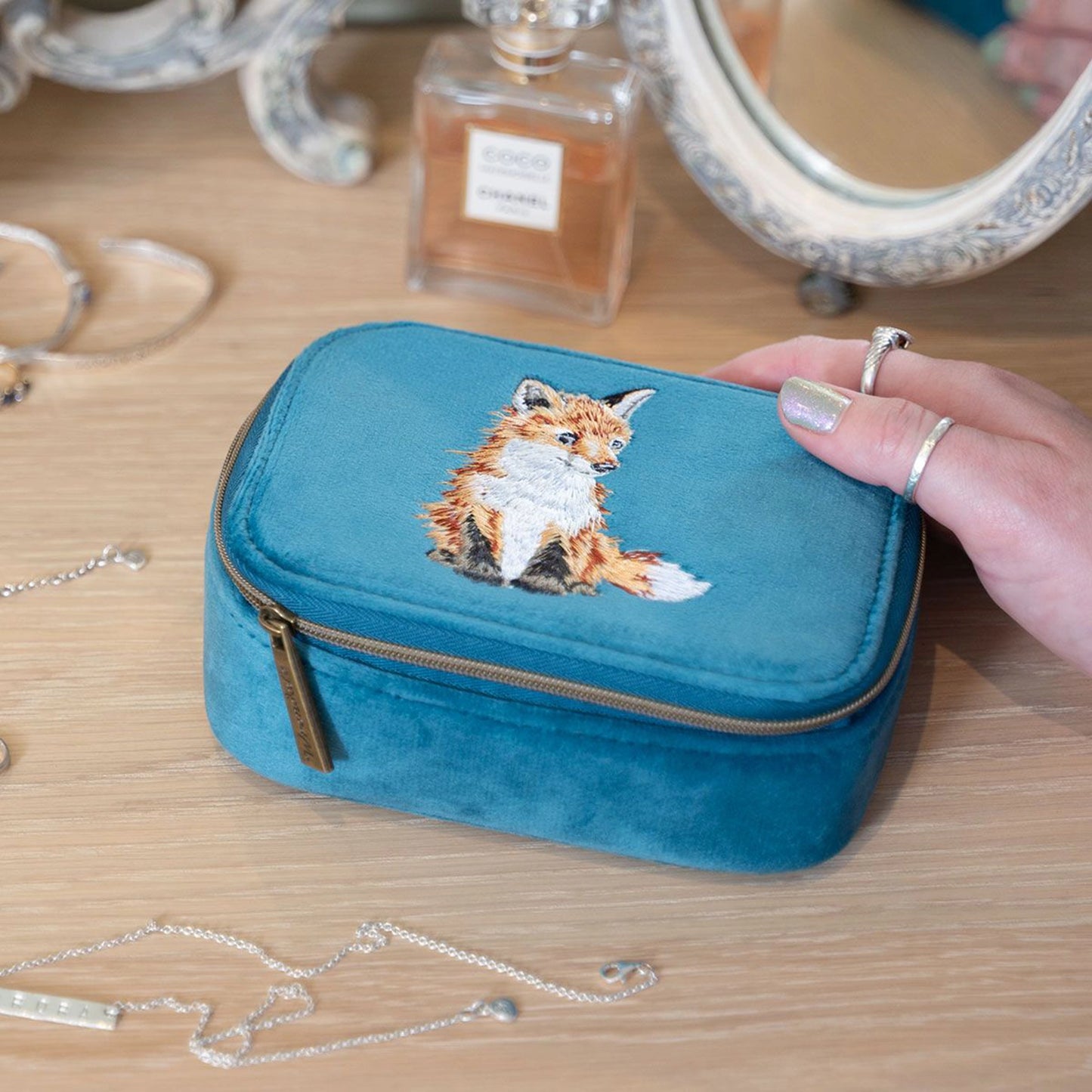 Blue faux suede zip accessory case with embroidered fox design lifestyle