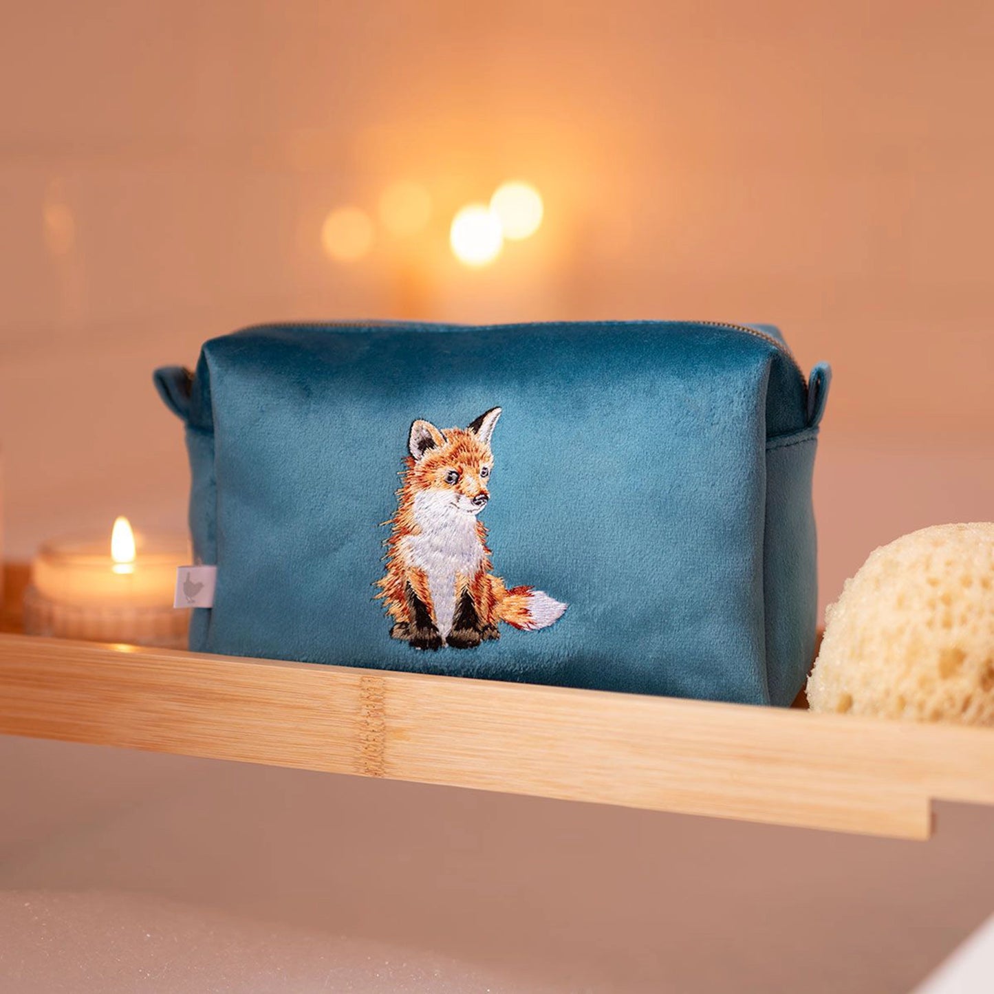 Blue make up bag with embroidered fox design and zip top lifestyle