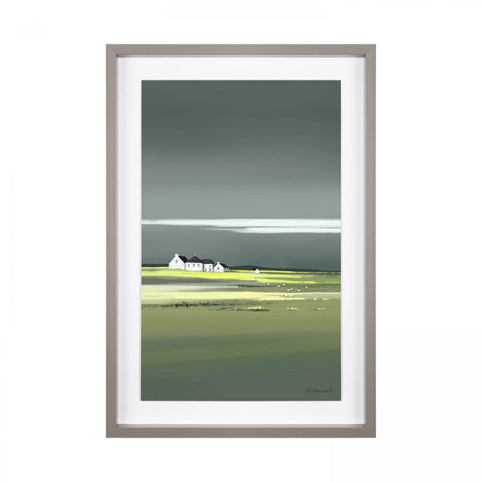 Framed print of a coastal scene in greens and blues with a cluster of white cottages on the horizon.