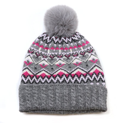Knitted fair isle patterned hat in grey and pink with faux fur pompom and cable knit turn up