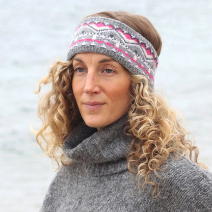 Model wearing knitted fair isle patterned headband in grey and pink