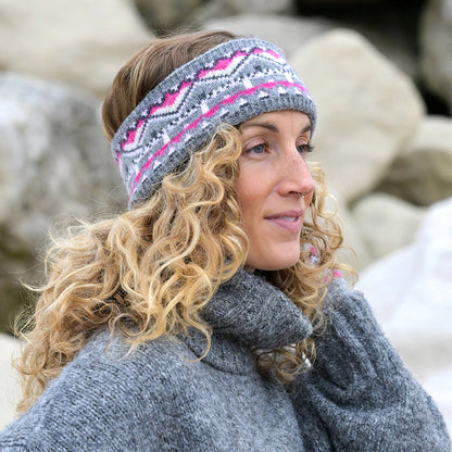 Model wearing knitted fair isle patterned headband in grey and pink
