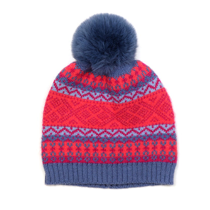 A knitted hat with fair isle pattern in blue, red and pink and a faux fur pompom