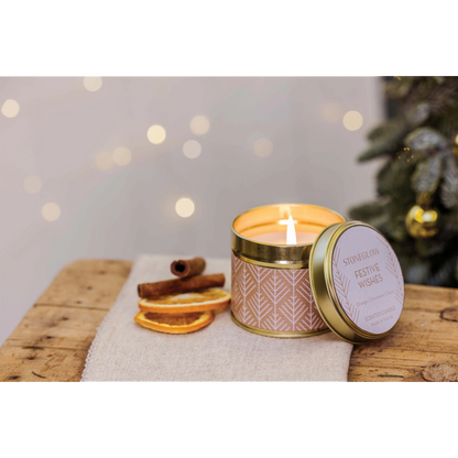 A gold tine candle with scandi style white pattern on brown paper in the scene 'Festive Wishes' - Lifestyle