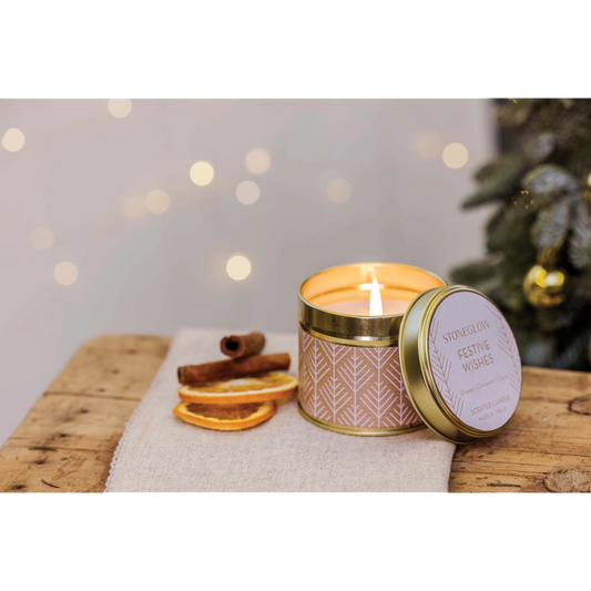 A gold tine candle with scandi style white pattern on brown paper in the scene 'Festive Wishes' - Lifestyle