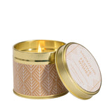 A gold tine candle with scandi style white pattern on brown paper in the scene 'Festive Wishes'