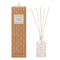 A glass reed diffuser with a box decorated in a white Scandi style pattern