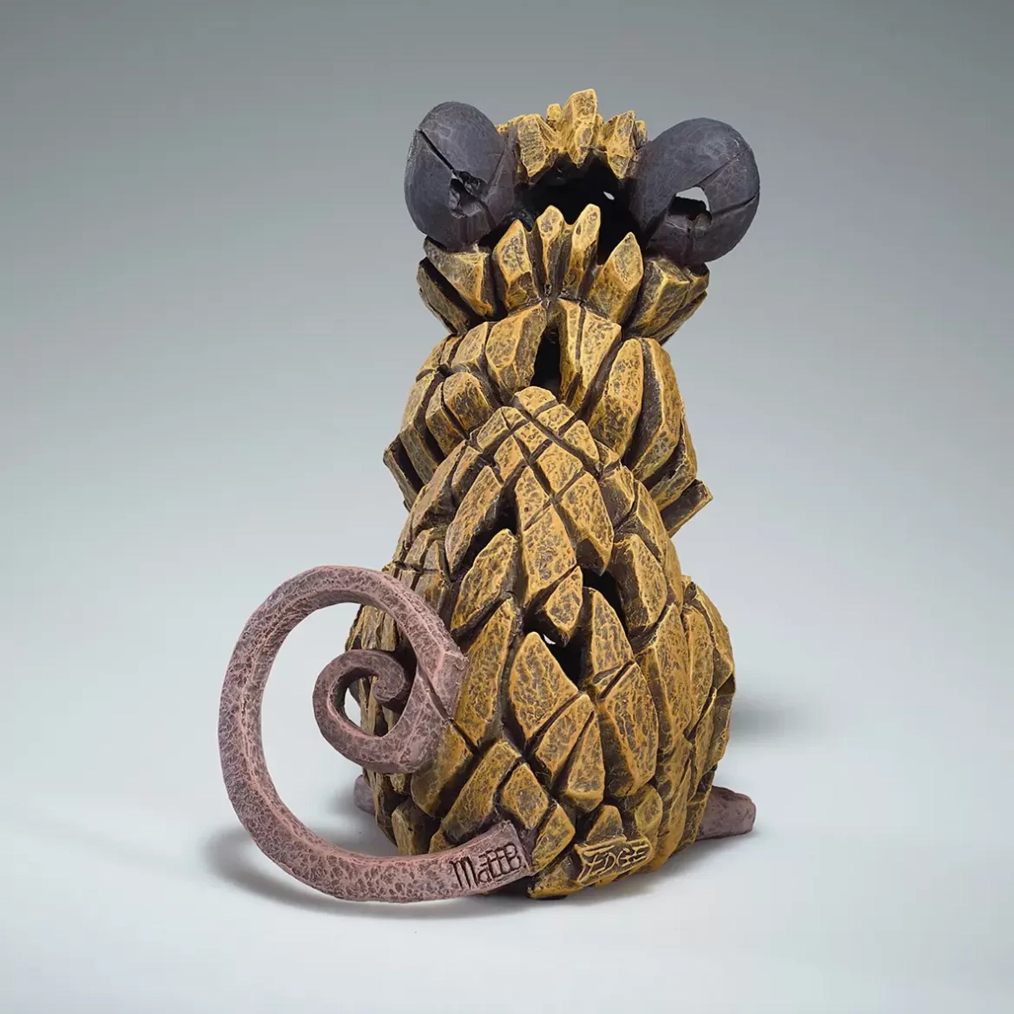 A painted sculpture of a field mouse back view with signature