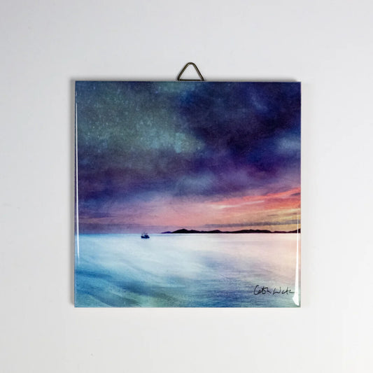 A ceramic tile featuring a water and sky scene painting by Cath Waters