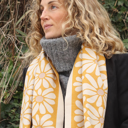 Model wearing yellow and white reversible floral scarf