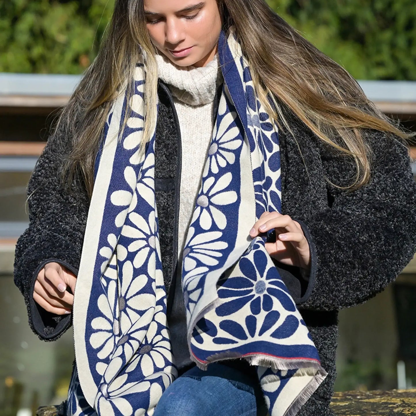 Model wearing navy and white reversible floral scarf