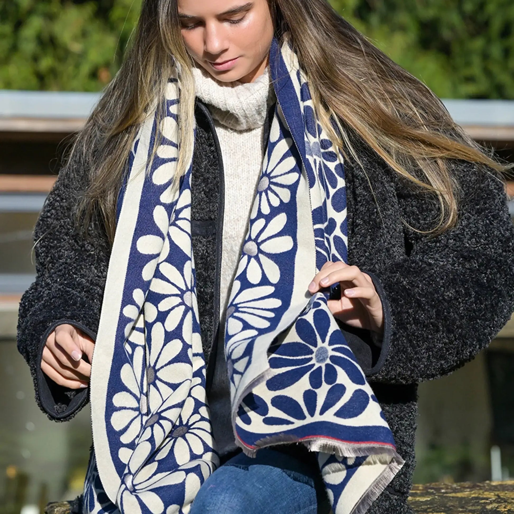 Model wearing navy and white reversible floral scarf